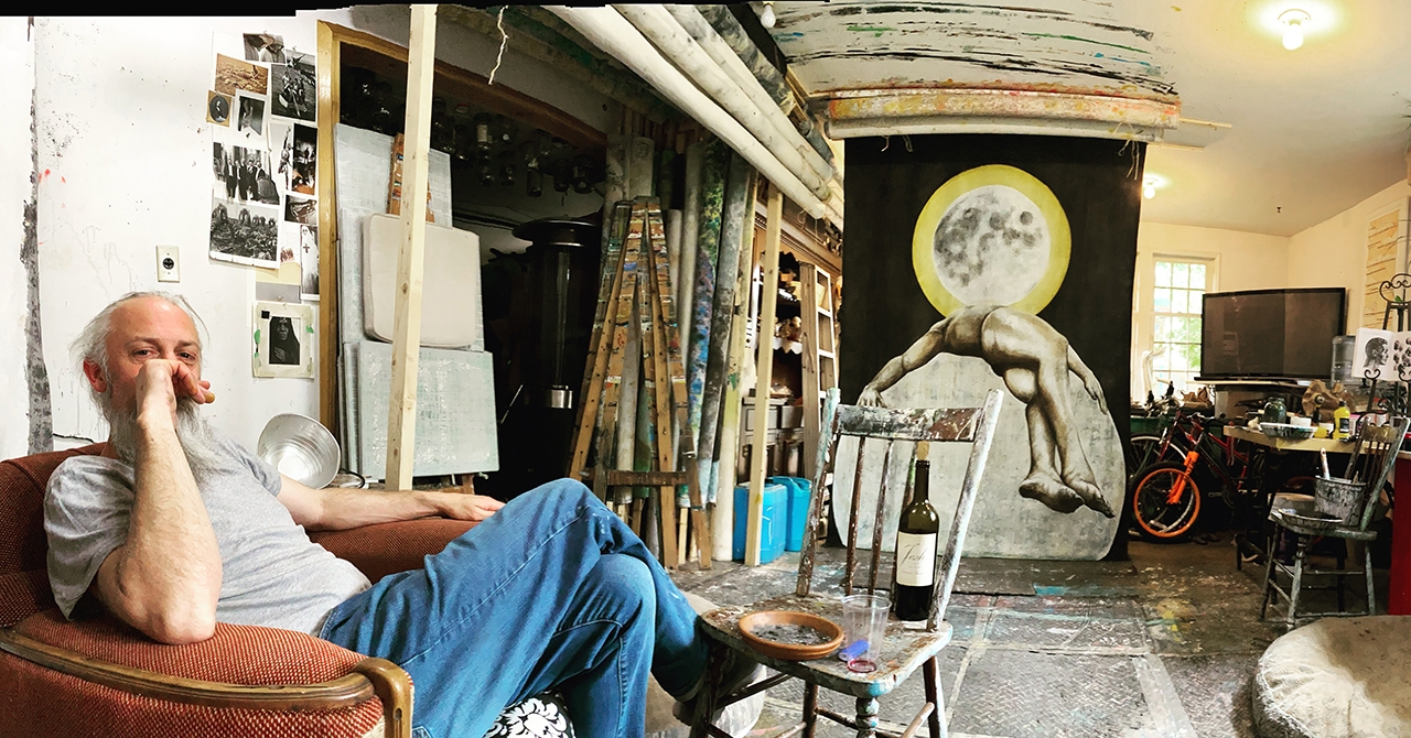 Terry P. Daly in his art studio surronded by paintings